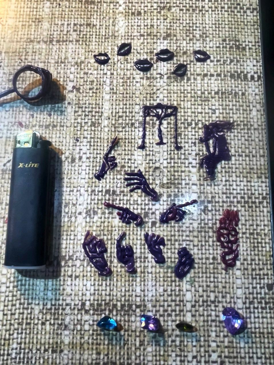 Wax models of hands and lips carved by Momik, on burlap.