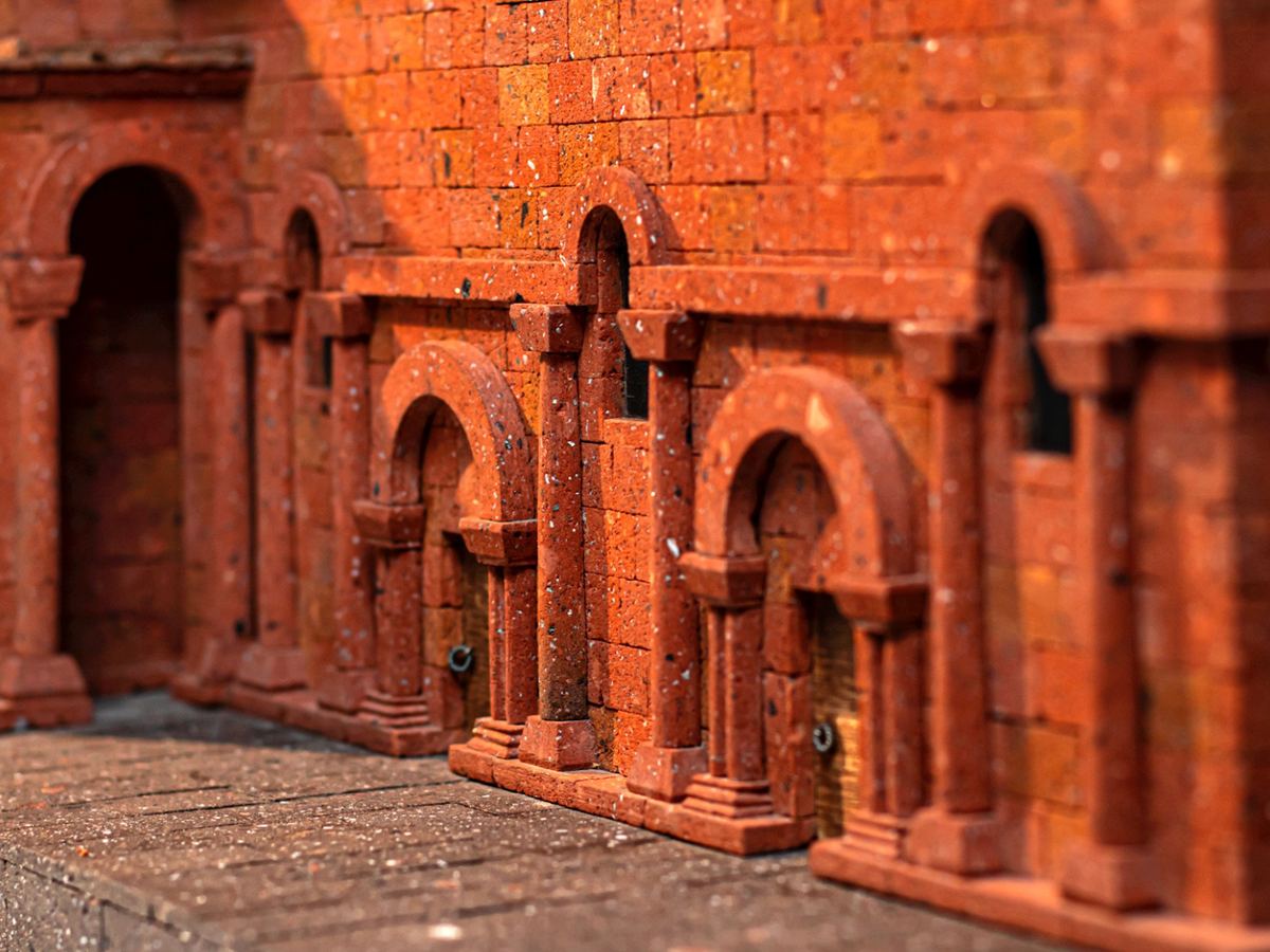 Façade of a red tufa maquette with carved arches, from Samvel Hakobyan's workshop.
