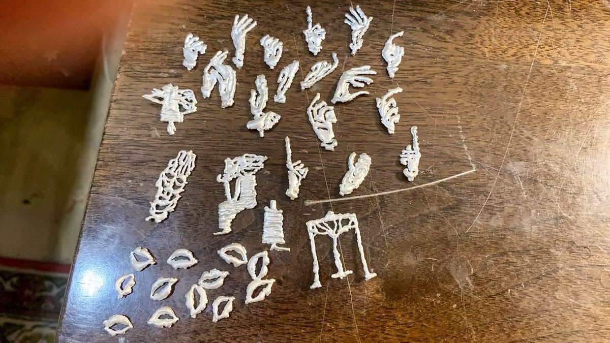 Freshly cast pieces on a wooden workshop table.