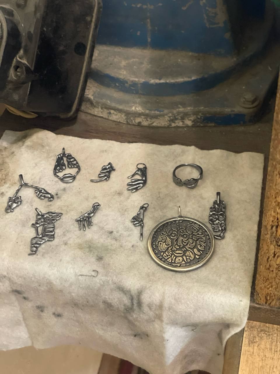 Pieces on a cloth beside the workshop polishing motor.