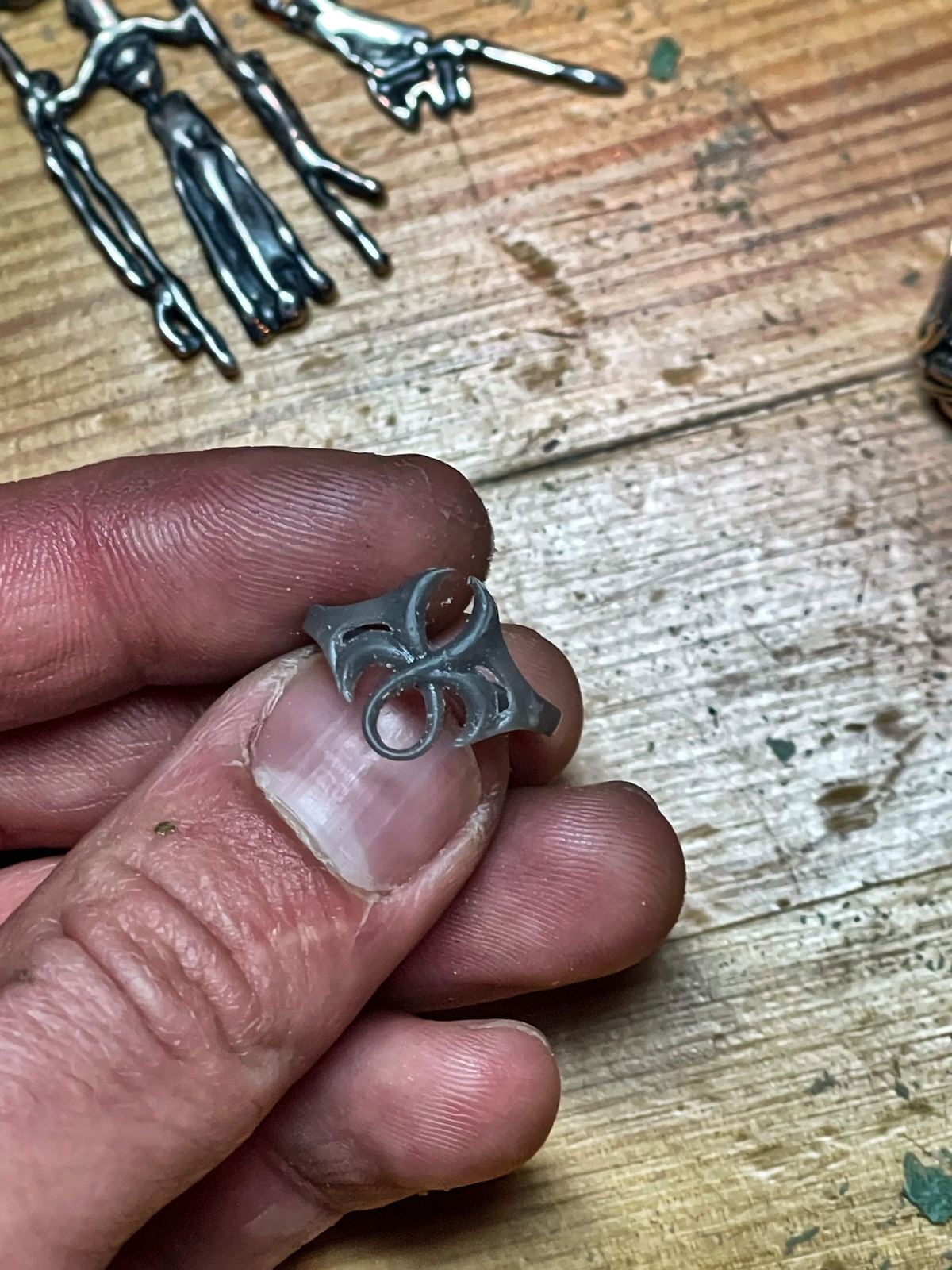 Printed master model of an ornament ring held between fingers (process, not a piece for sale).